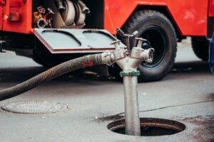 Vacuum truck performing professional sewer pump-out service in Staten Island.